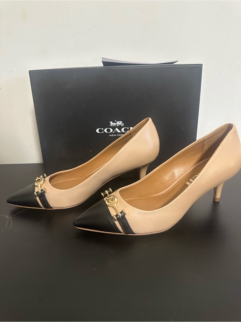 Coach Two-Tone Leather Pointed Toe Pumps in Beige and Black with Gold Accent